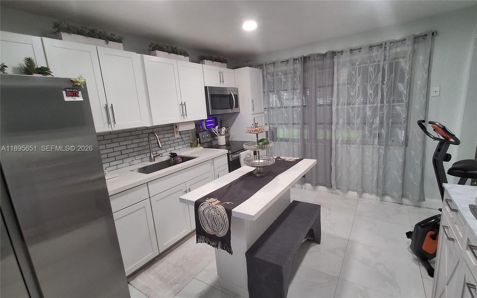 10305 Southwest 149th Terrace Miami, FL 33176 - Photo 22 of 58 a kitchen with a sink cabinets and appliances