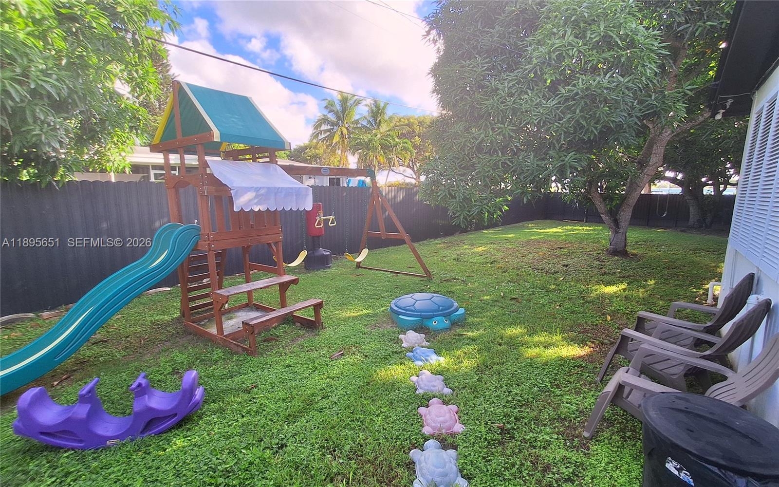 10305 Southwest 149th Terrace Miami, FL 33176 - Photo 25 of 58 a view of a backyard with table and chairs