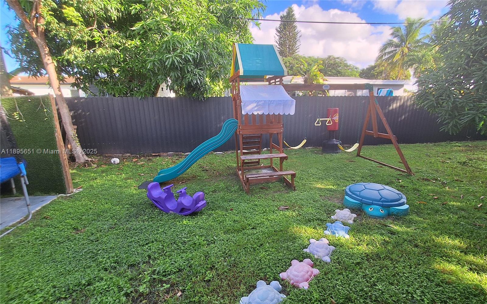 10305 Southwest 149th Terrace Miami, FL 33176 - Photo 27 of 39 a backyard of a house with table and chairs