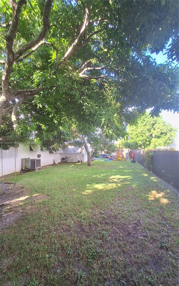 10305 Southwest 149th Terrace Miami, FL 33176 - Photo 35 of 39 a view of a house with a yard