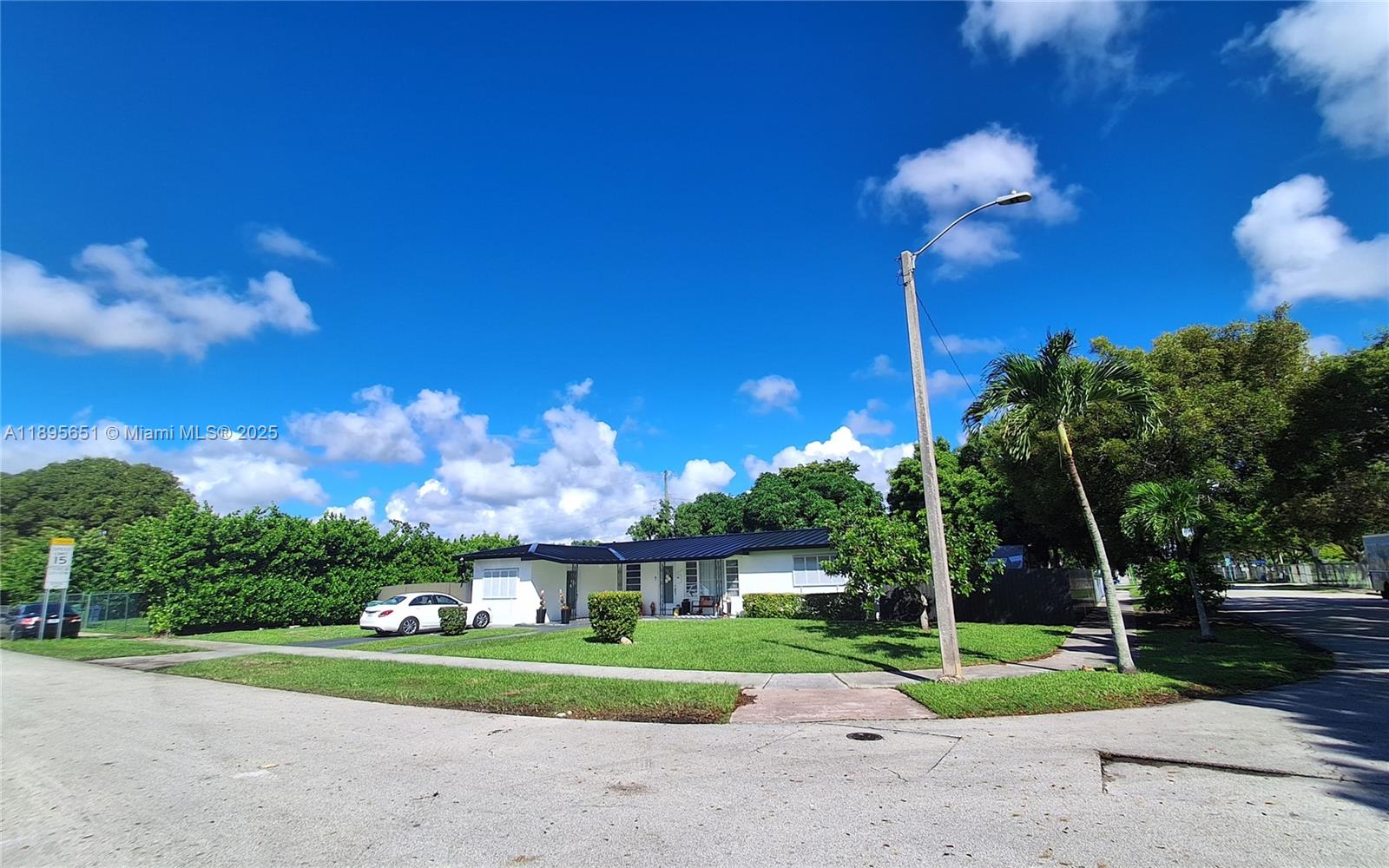 10305 Southwest 149th Terrace Miami, FL 33176 - Photo 38 of 39 a view of a house with a yard and a large tree