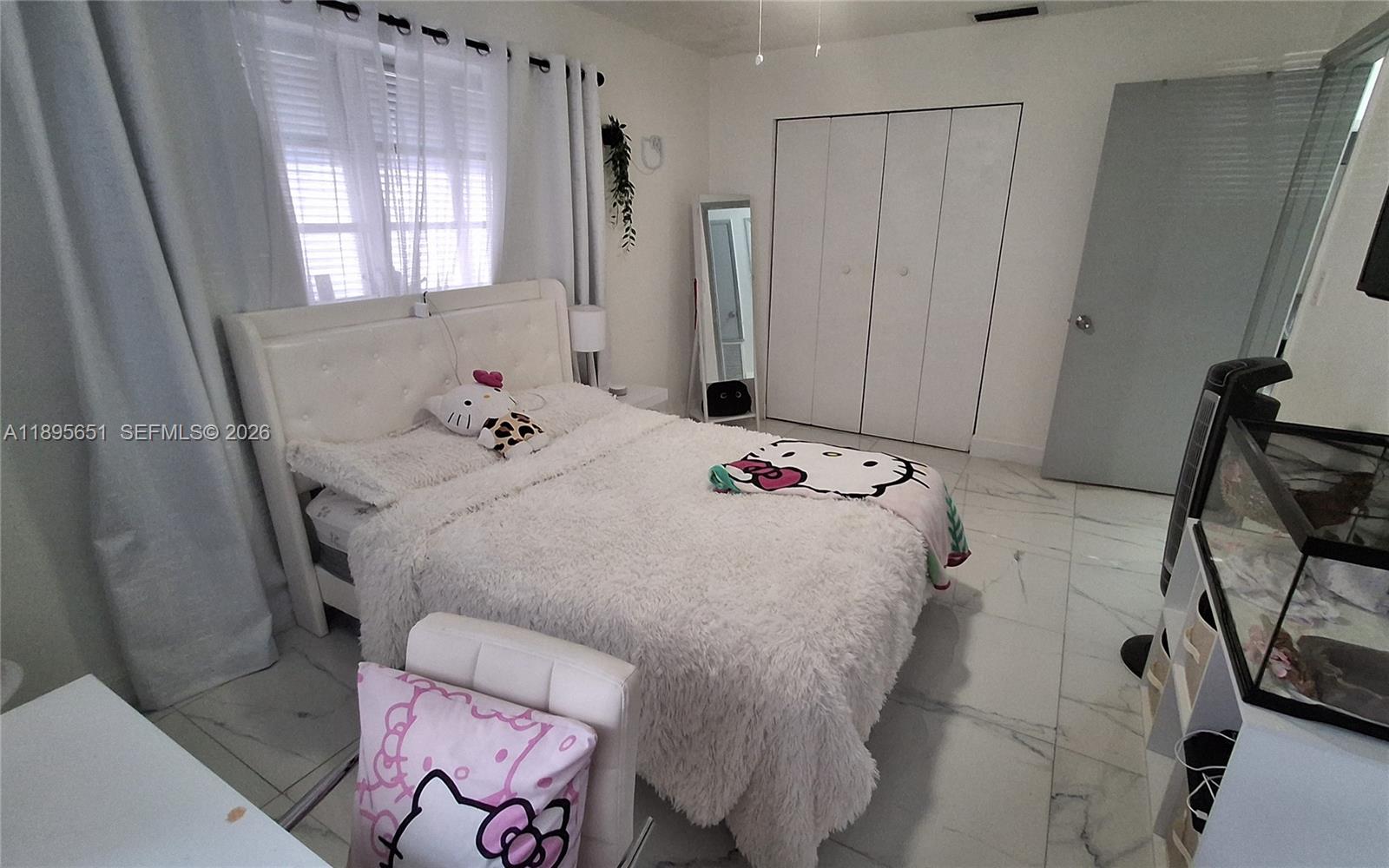 10305 Southwest 149th Terrace Miami, FL 33176 - Photo 5 of 58 a bedroom with a bed and a dresser