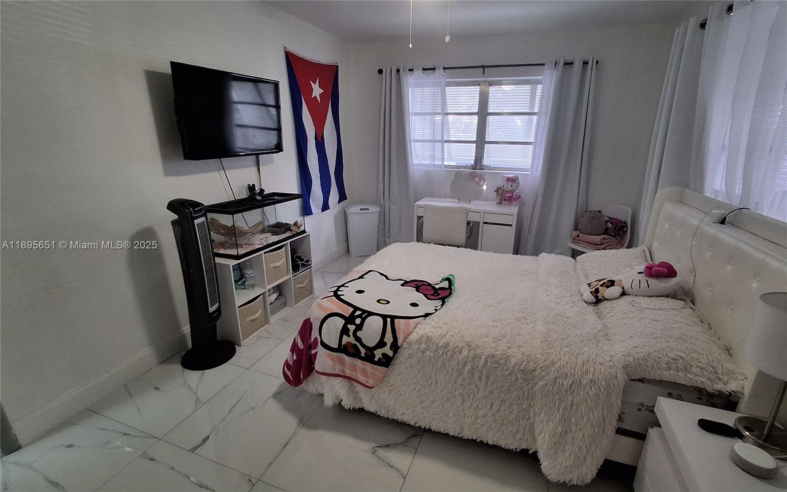 10305 Southwest 149th Terrace Miami, FL 33176 - Photo 5 of 39 a bedroom with a bed and flat screen tv