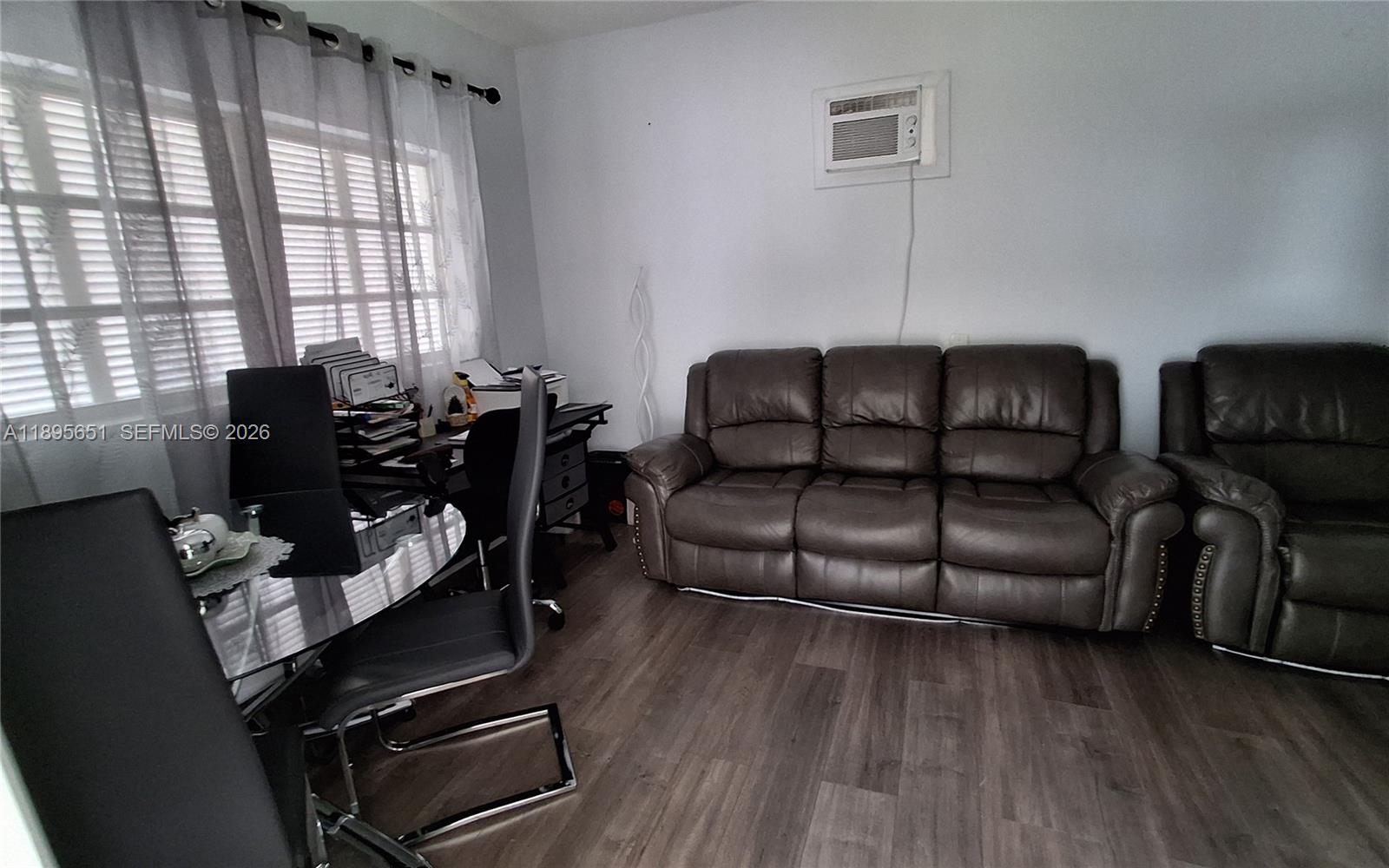 10305 Southwest 149th Terrace Miami, FL 33176 - Photo 55 of 58 a living room with furniture rug and wooden floor