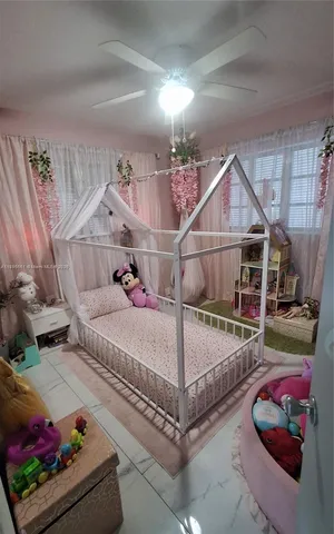 a bed sitting in a room next to a window