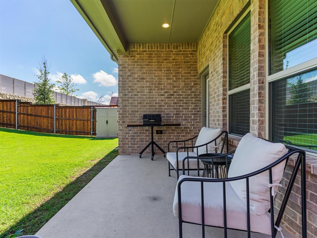 166 Palo Duro Bend Rhome, TX 76078 - Photo 33 of 40 Covered patio overlooking the backyard, ideal for outdoor relaxation.