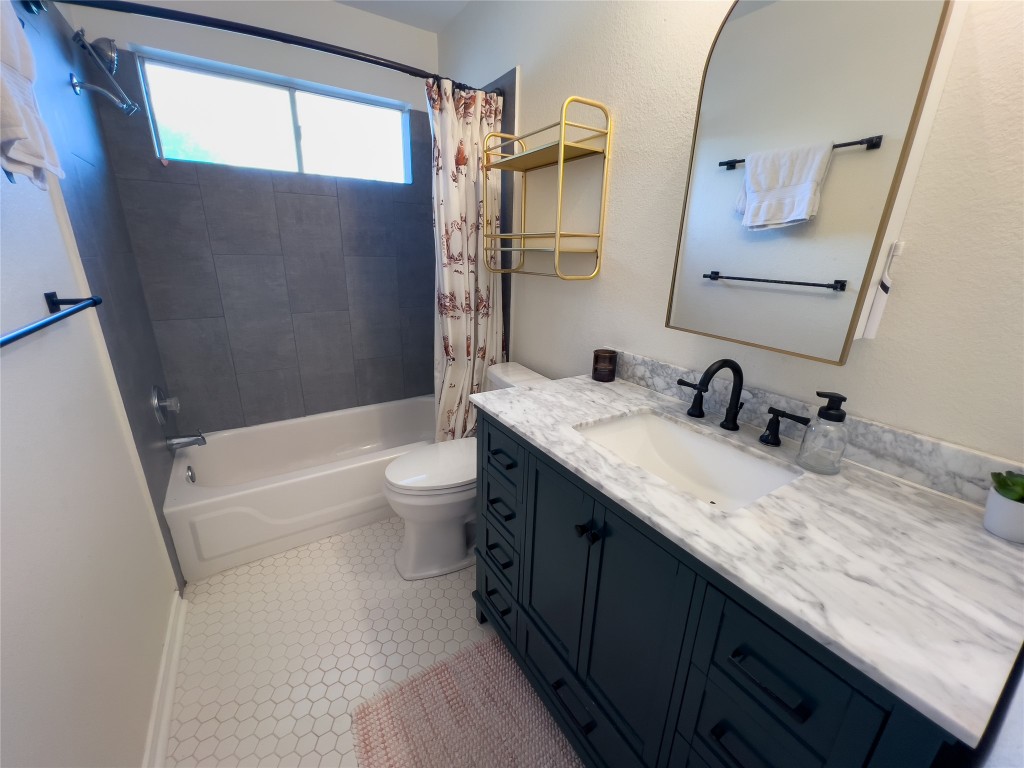 8908 West Hove Loop Austin, TX 78749 - Photo 15 of 20 a bathroom with a granite countertop sink a toilet and shower