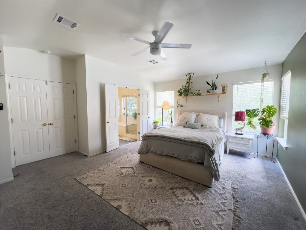 8908 West Hove Loop Austin, TX 78749 - Photo 16 of 20 a spacious bedroom with a bed and a chandelier