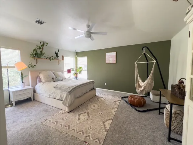a bathroom with a tub shower vanity and a sink