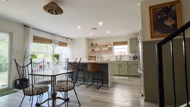 a view of a backyard with table and chairs under an umbrella with a small yard