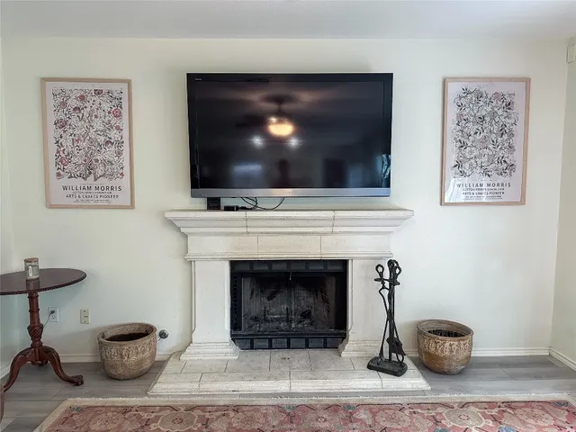 a living room with furniture a fireplace and a chandelier