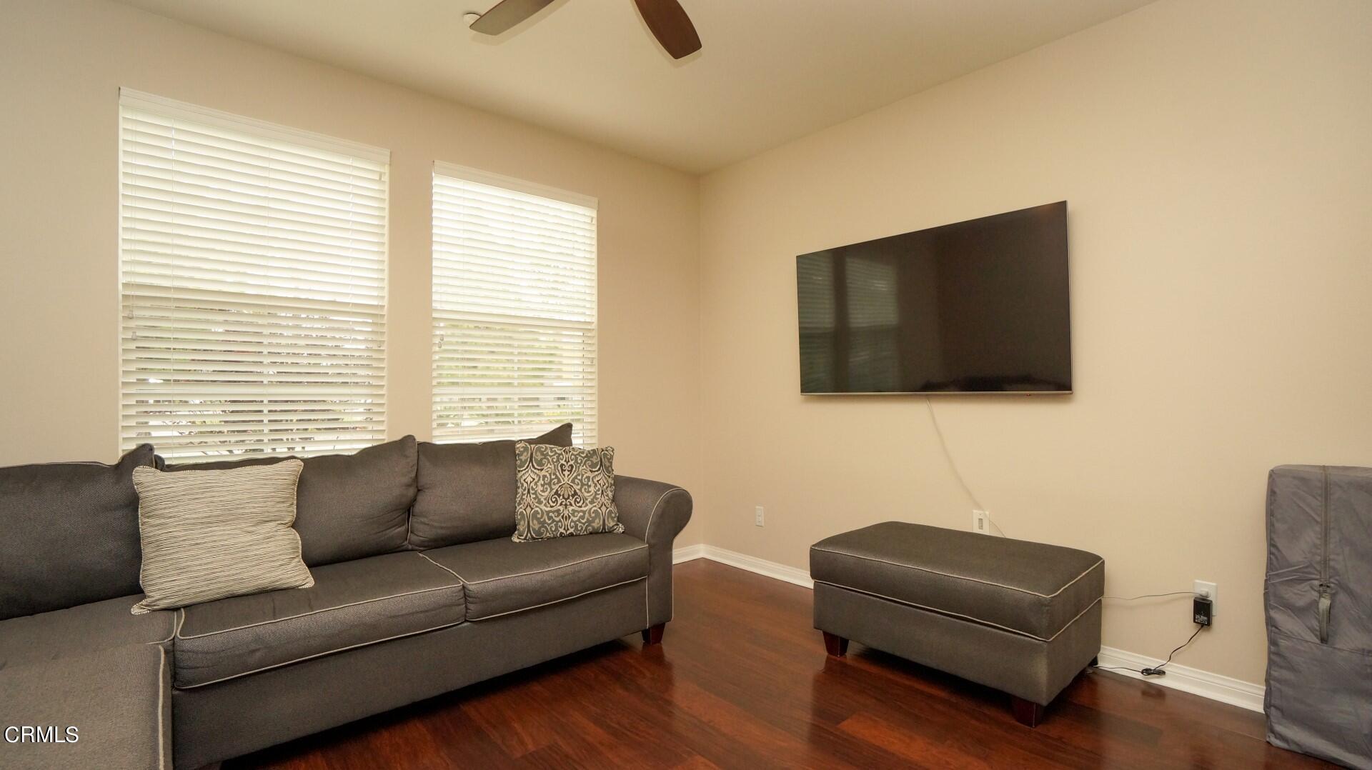 729 Forest Park Boulevard Oxnard, CA 93036 - Photo 3 of 27 a living room with furniture a flat screen tv and a window