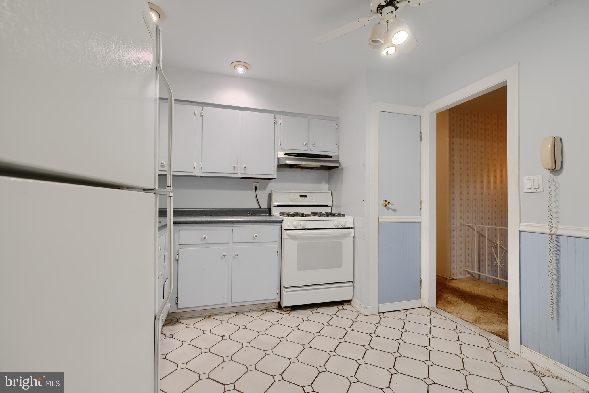 113 Doncaster Road Joppa, MD 21085 - Photo 12 of 43 a kitchen with a stove a sink and a refrigerator