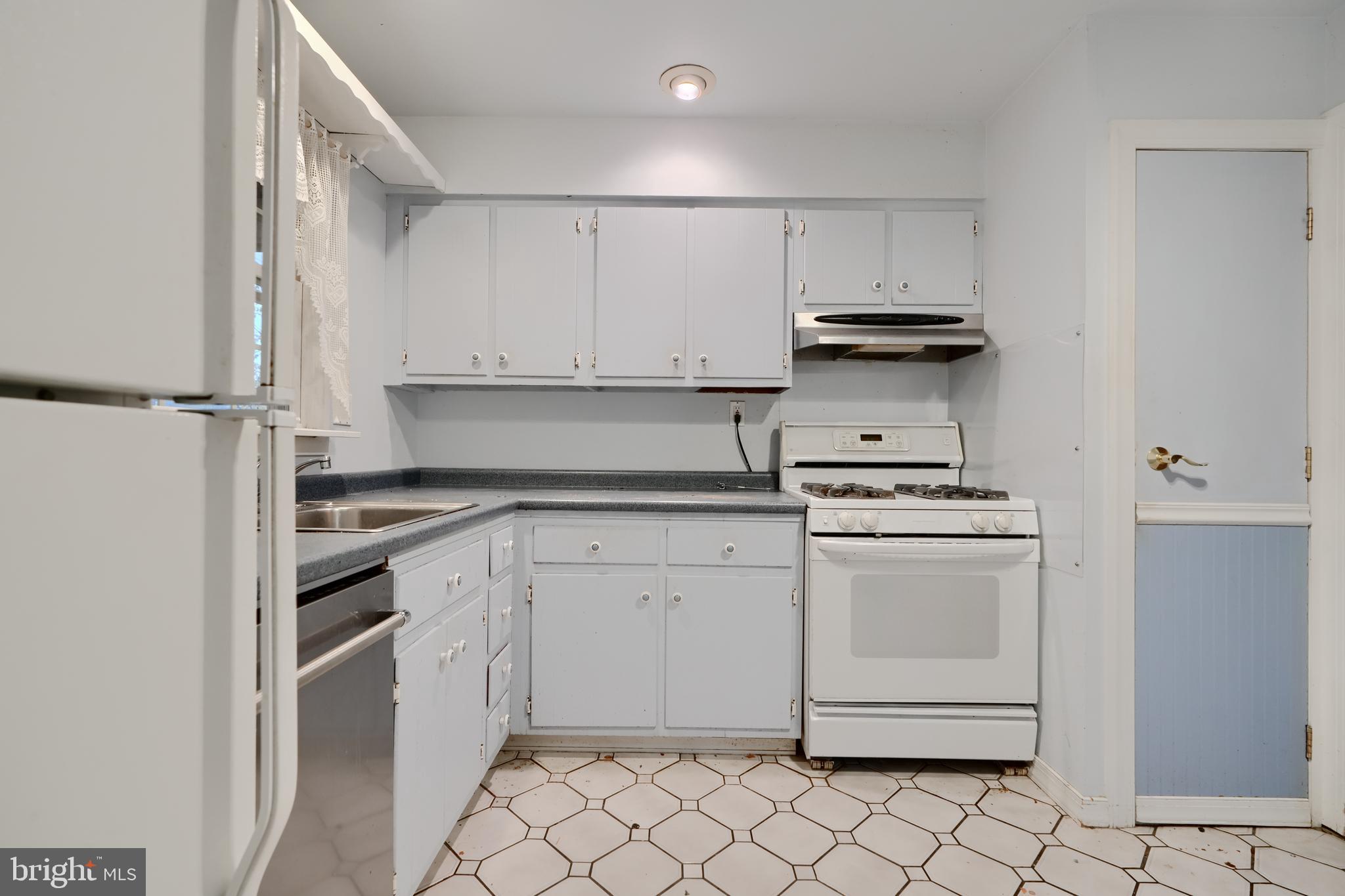 113 Doncaster Road Joppa, MD 21085 - Photo 13 of 43 a kitchen with white cabinets and white appliances