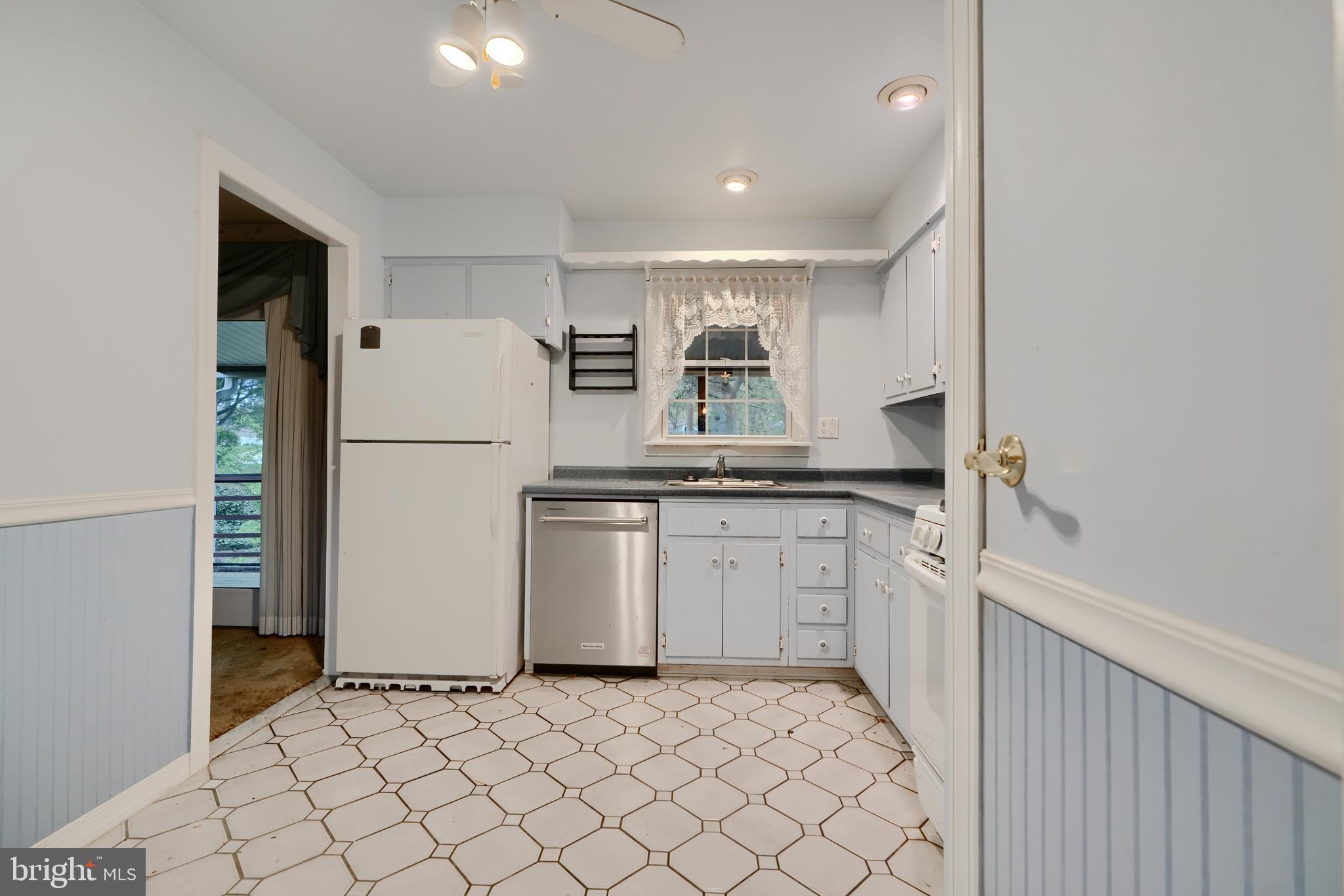 113 Doncaster Road Joppa, MD 21085 - Photo 14 of 43 a kitchen with white cabinets and refrigerator
