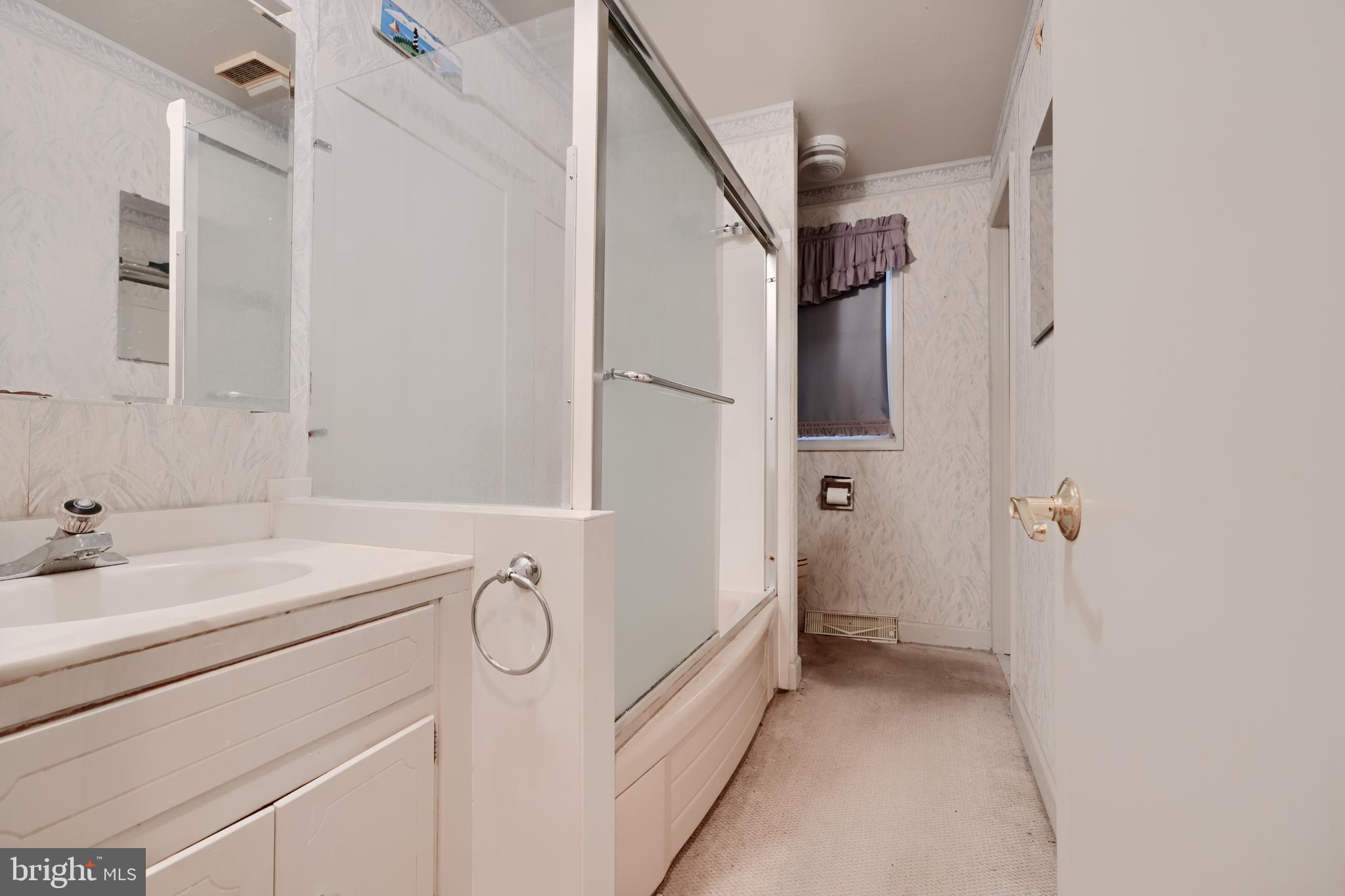 113 Doncaster Road Joppa, MD 21085 - Photo 24 of 43 a bathroom with a granite countertop sink a mirror a vanity and a shower