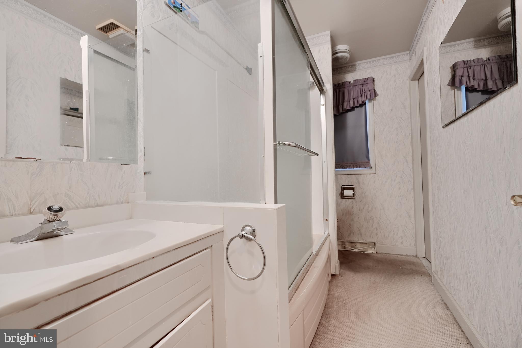 113 Doncaster Road Joppa, MD 21085 - Photo 25 of 43 a bathroom with a granite countertop sink a mirror and shower