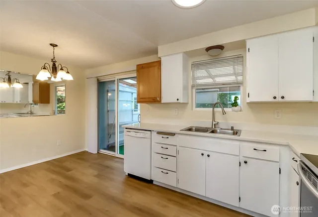 a kitchen with granite countertop white cabinets and white appliances