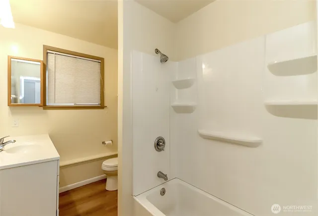 a bathroom with a tub a toilet and a sink