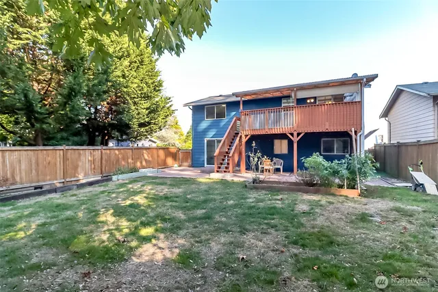 a view of a house with a yard and sitting area
