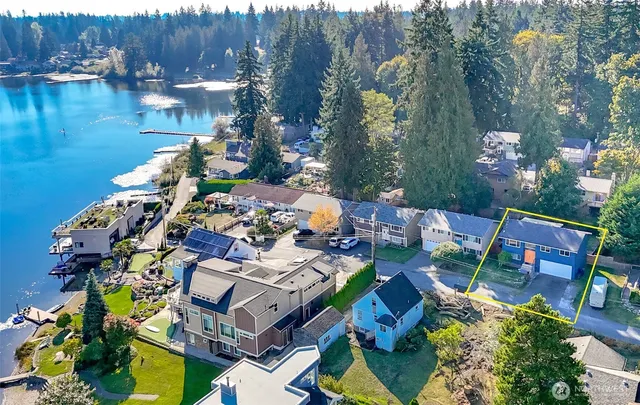 an aerial view of a house with a lake view