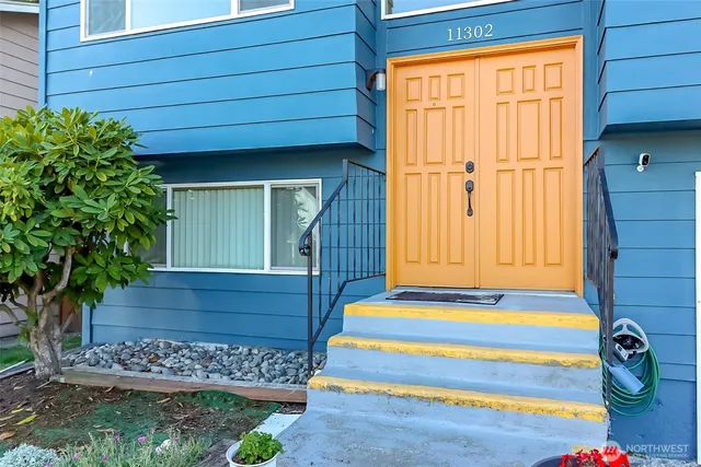 a front view of a house with a garden