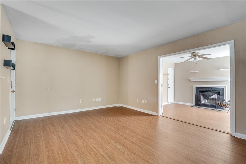 134 Lablanc Way Northwest Atlanta, GA 30327 - Photo 7 of 42 an empty room with wooden floor fireplace and windows