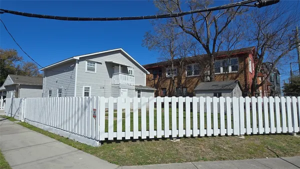 a front view of a house with a small yard