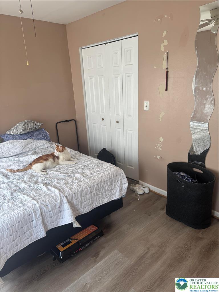 911 Marion Street Reading, PA 19604 - Photo 13 of 16 a bedroom with a bed and wooden floor