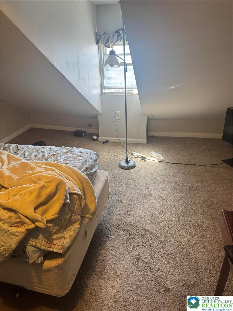 911 Marion Street Reading, PA 19604 - Photo 6 of 16 a bed sitting in a bedroom next to a window