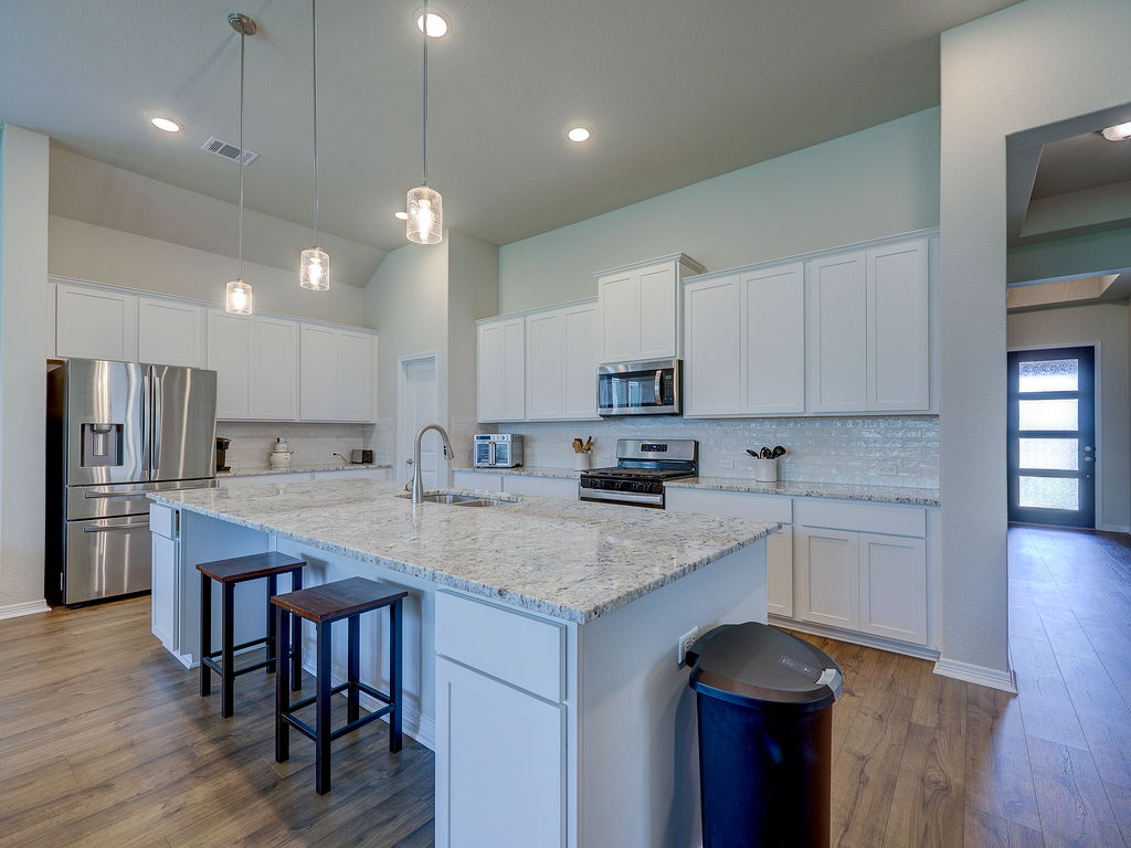229 Heartleaf Road San Marcos, TX 78666 - Photo 11 of 40 Culinary creations come to life in this kitchen with an island, granite counters, and modern appliances.