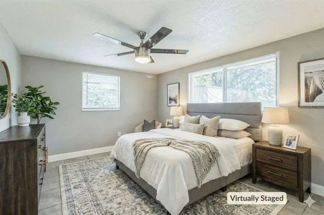 a bedroom with a bed and a potted plant