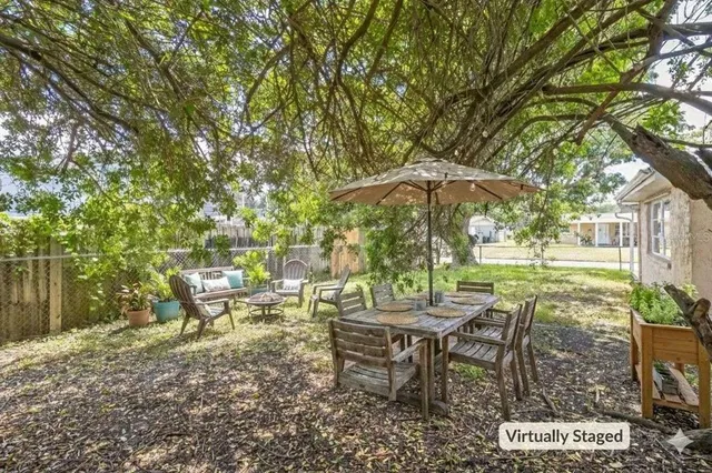 a view of a chairs and table in backyard