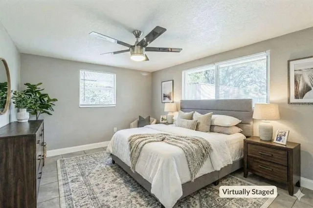 a bedroom with a bed and a potted plant