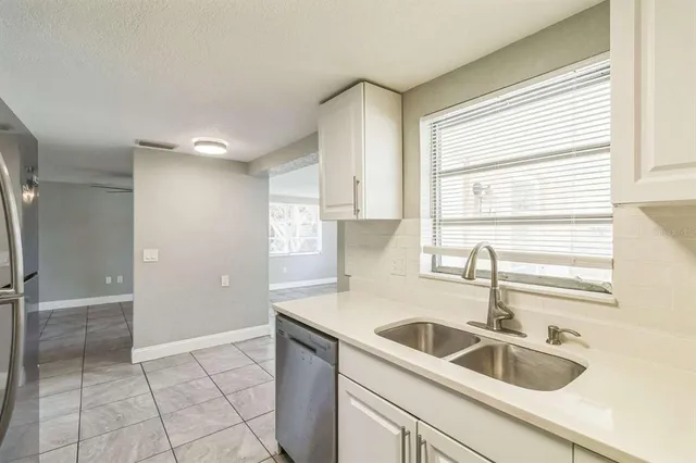 a kitchen with a sink cabinets and window