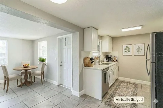 a view of a kitchen area with furniture and wooden floor