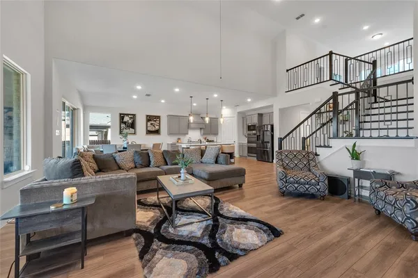 a living room with furniture and wooden floor