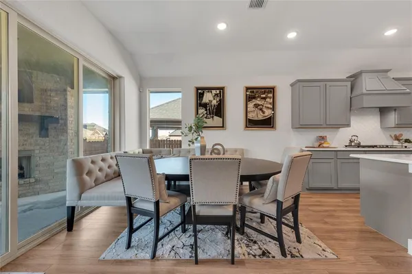 a view of a dining room with furniture and wooden floor