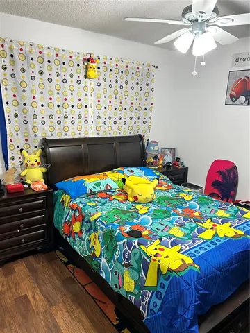 a bedroom with a bed and a lamp on dresser