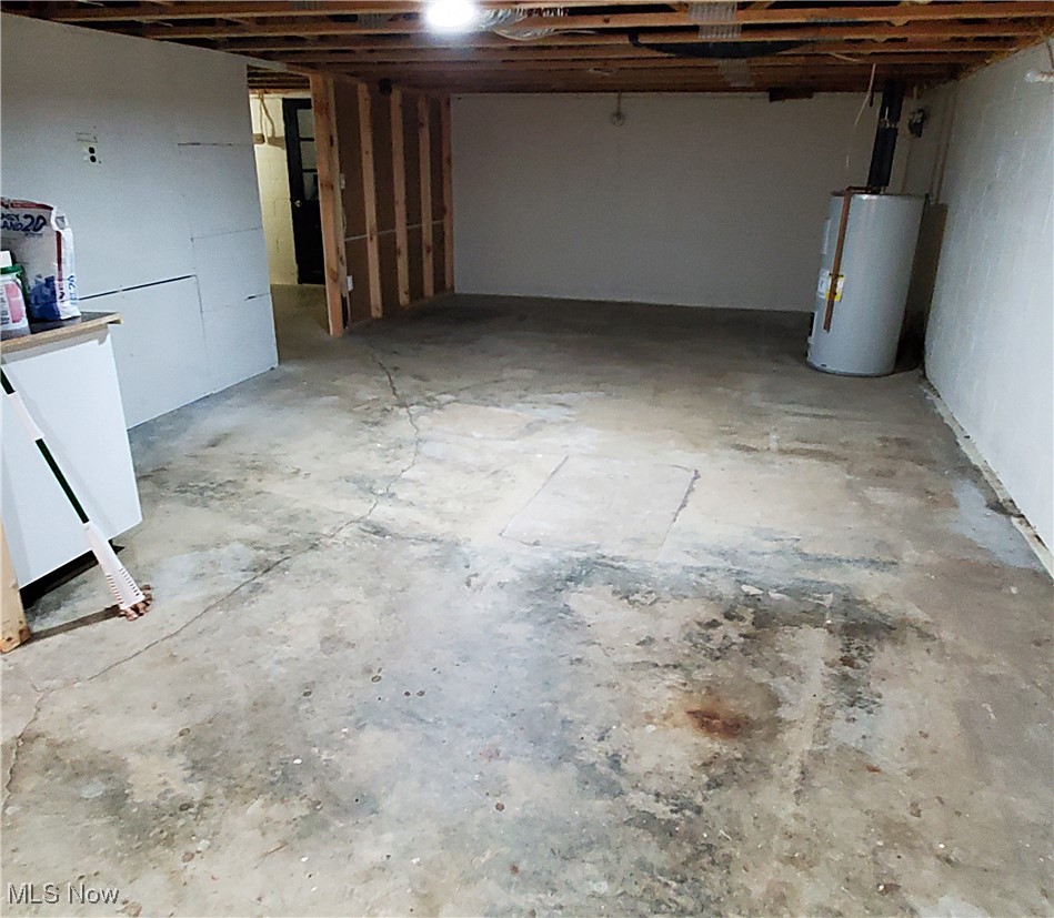 13075 Conquer Hill Road Byesville, OH 43723 - Photo 28 of 36 Unfinished basement featuring electric water heater