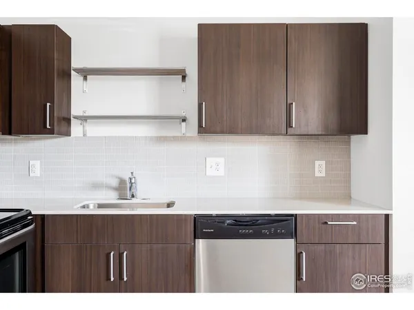 a kitchen with a sink cabinets and a stove top oven