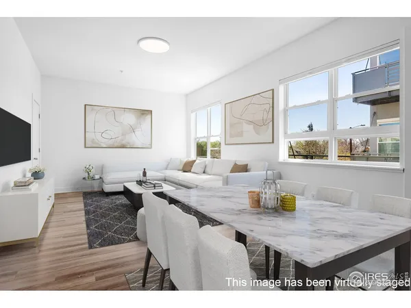 a dining room with furniture and wooden floor