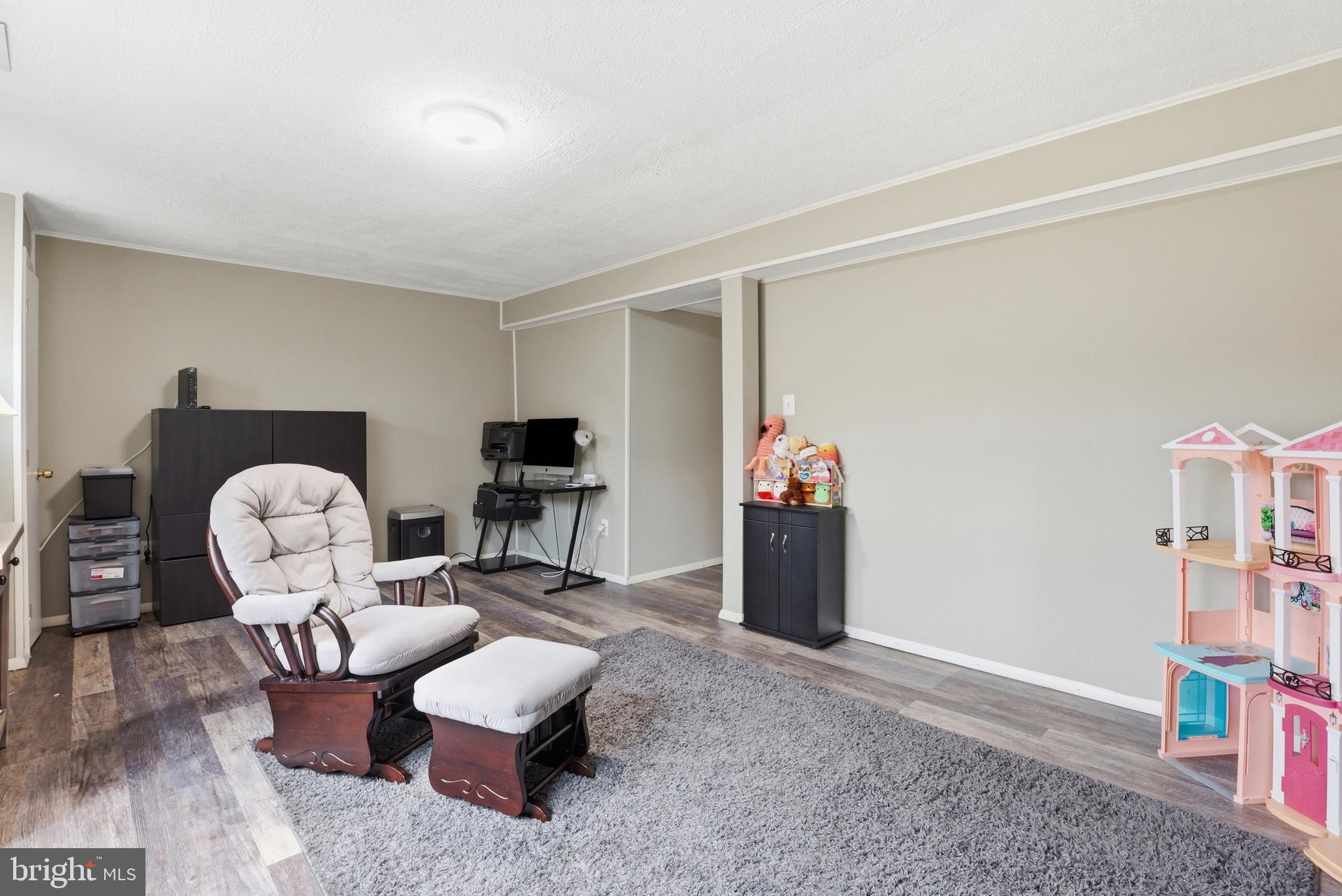 10504 Apple Ridge Road Gaithersburg, MD 20886 - Photo 25 of 33 a living room with furniture and a flat screen tv