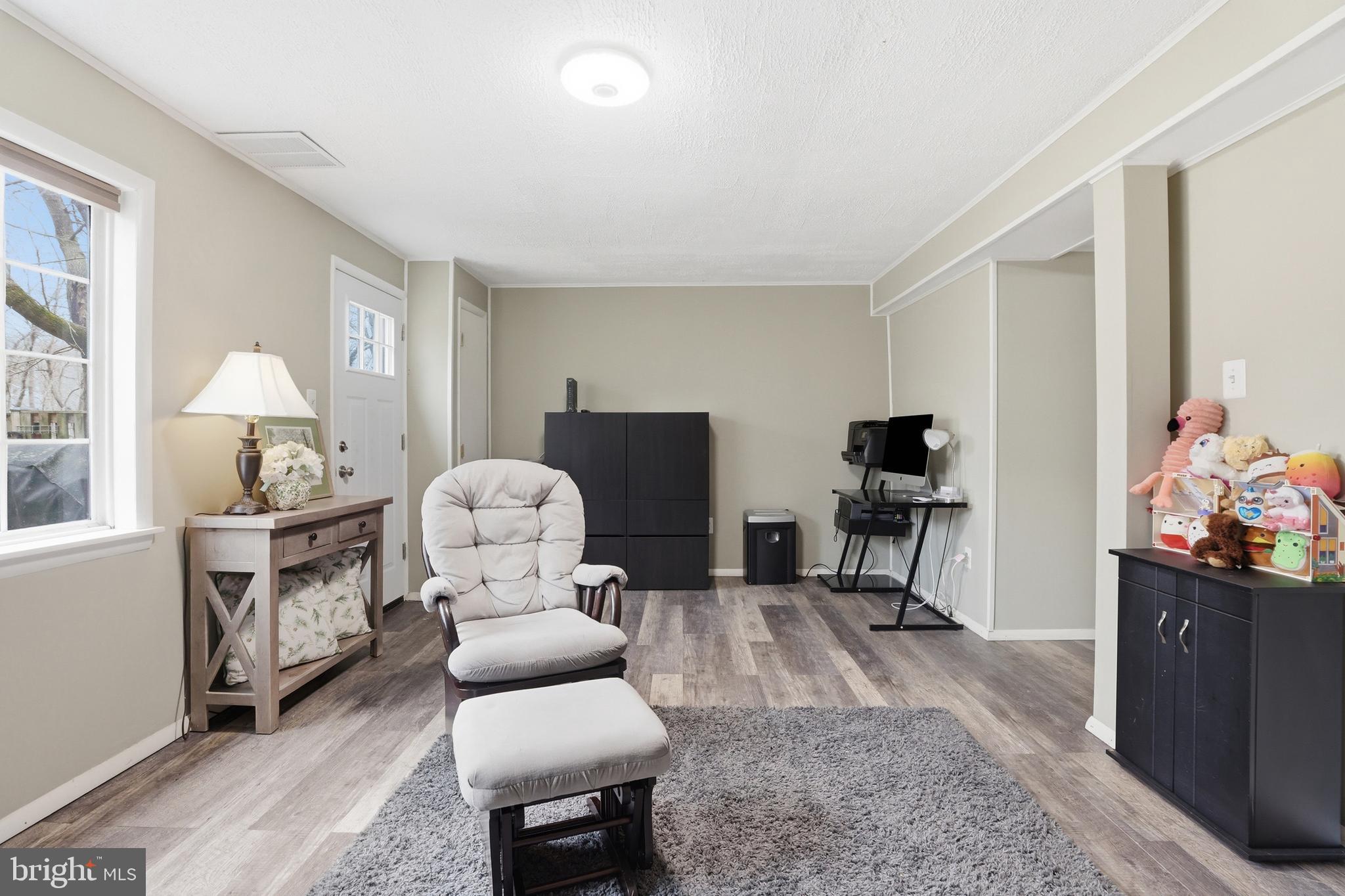 10504 Apple Ridge Road Gaithersburg, MD 20886 - Photo 26 of 33 a living room with furniture and a flat screen tv