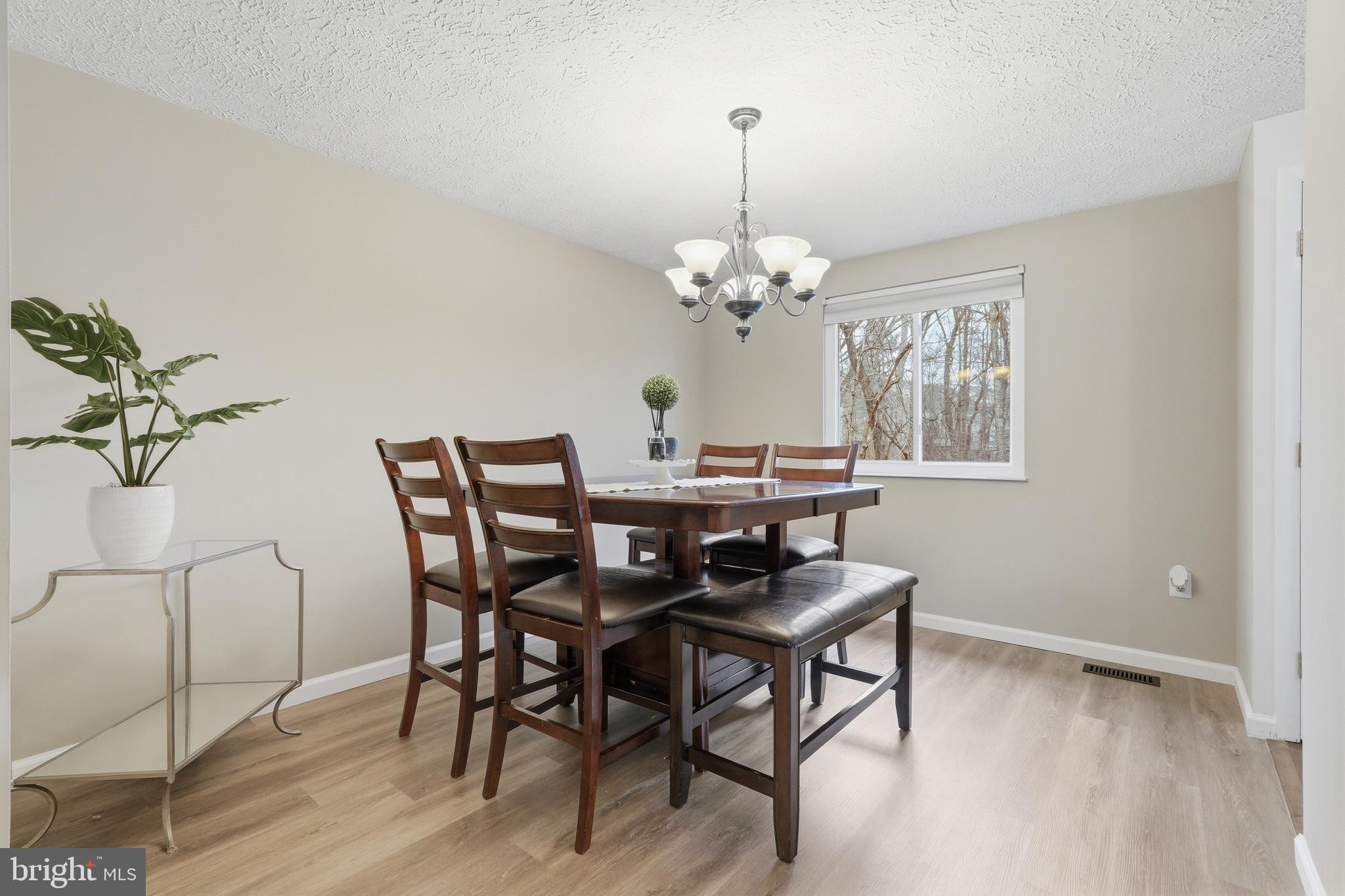 10504 Apple Ridge Road Gaithersburg, MD 20886 - Photo 8 of 33 a dining room with furniture and chandelier