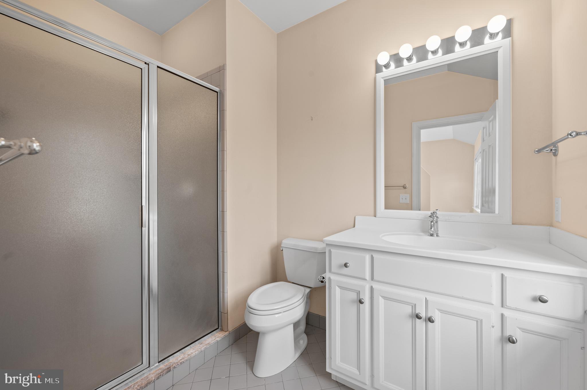 1659 Boot Road West Chester, PA 19380 - Photo 48 of 65 a bathroom with a toilet sink vanity and mirror