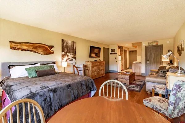 a bedroom with two beds and a dresser