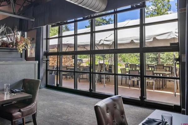 a lobby with furniture and floor to ceiling window