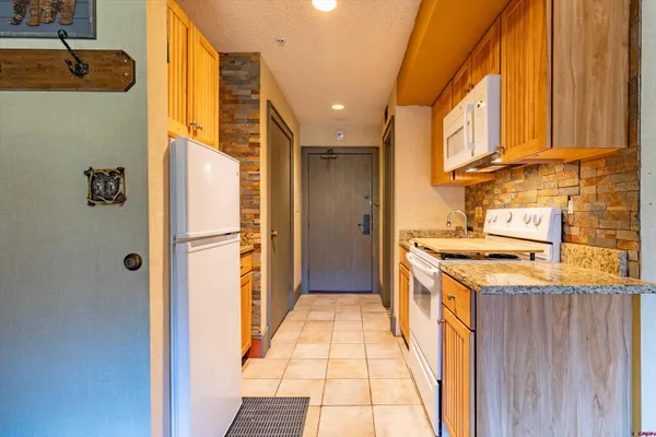 a kitchen with a refrigerator and a stove