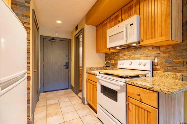 a kitchen with a stove a sink and a refrigerator